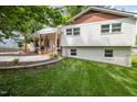 Charming two-story home with a brick foundation, white siding, and a well-maintained lawn at 5505 Knollwood Rd, Raleigh, NC 27609
