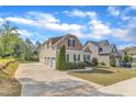 A view of this two-story residence showcasing the extended driveway and attached garages at 615 Prides Crsg Xing, Rolesville, NC 27571