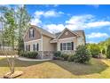 An eye-level of this two-story home highlighting the well-maintained lawn and inviting front entrance at 615 Prides Crsg Xing, Rolesville, NC 27571