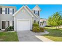Charming townhouse with a well-maintained lawn, driveway, and mature trees at 6539 Clarksdale Ln, Durham, NC 27713