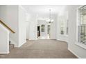 Bright living room features neutral paint, plush carpet and natural light at 6539 Clarksdale Ln, Durham, NC 27713