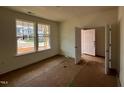 Bedroom with a door to the hall, natural light, and neutral walls at 788 Old Station Pointe, Angier, NC 27501