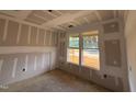 Unfinished bedroom featuring natural light from double hung windows during the construction phase at 788 Old Station Pointe, Angier, NC 27501