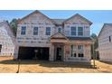 New construction two-story home with attached garage, covered porch and traditional design elements at 788 Old Station Pointe, Angier, NC 27501