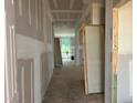 Unfinished hallway featuring white walls, and doors throughout the home during the construction phase at 788 Old Station Pointe, Angier, NC 27501
