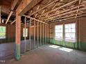 Unfinished interior showcasing the framing, windows, and layout of the new construction home at 788 Old Station Pointe, Angier, NC 27501