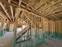 Unfinished interior featuring the stairway framing, exposed beams and open-concept design at 788 Old Station Pointe, Angier, NC 27501