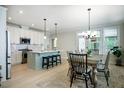 Open kitchen boasts an island with barstool seating and modern appliances at 83 Vandalia Ave, Chapel Hill, NC 27516
