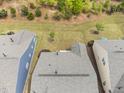 Aerial view of roof surrounded by green trees and neighboring homes at 10 Currituck Ln, Durham, NC 27703