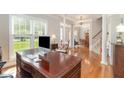 Spacious office area with a large desk, hardwood floors, and bright, natural light at 1003 Fairfax Woods Dr, Apex, NC 27502