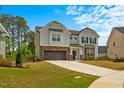 Beautiful two-story home with a manicured lawn and a spacious two-car garage at 1005 Whispering Creek Ct, Knightdale, NC 27545