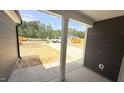 View from the covered entry shows construction and surrounding wooded area at 102 Gobbler Dr, Smithfield, NC 27577