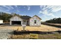 New construction home featuring a two-car garage with wrapped exterior walls at 102 Gobbler Dr, Smithfield, NC 27577