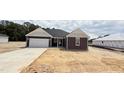 Charming new construction home with a two-car garage and unfinished landscaping at 102 Gobbler Dr, Smithfield, NC 27577