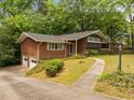 View of the home with an attached garage and front yard with a walkway to the front door at 1024 Chalmers St, Durham, NC 27707