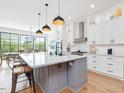 Modern kitchen with a large island, stainless appliances, and elegant finishes at 1027 S Duke St, Durham, NC 27707