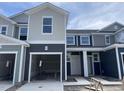 Townhome under construction featuring modern siding and garage with a construction staging area on the lot at 1029 Mountain Crown St, Durham, NC 27703