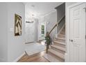 Welcoming foyer with hardwood floors, a staircase, and a view of the front door with sidelights at 105 Bergeron Way, Cary, NC 27519