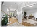 Open-concept living space with hardwood floors flowing into a dining room and a formal living room at 105 Bergeron Way, Cary, NC 27519
