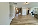 Open floor plan featuring hardwood floors, white cabinets, and access to the kitchen and stairs at 1091 Fairhaven Dr # 47, Mebane, NC 27302