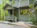 Close-up of the home's exterior, showcasing the porch, landscaping, and architectural style at 1213 Blackwood Mountain Rd, Chapel Hill, NC 27516