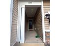 Covered entryway featuring modern lighting and natural brick accents at 1240 Grenshaw Dr, Morrisville, NC 27560
