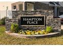 Stone sign with the name of the Hampton Place community surrounded by flowers at 1240 Grenshaw Dr, Morrisville, NC 27560