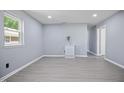 Bright living room with new gray flooring, fresh paint, and natural light at 1317 Proctor St, Rocky Mount, NC 27801