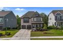Charming two-story home with brick facade, covered front porch, and well-manicured lawn at 1632 Ferntree Ct, Morrisville, NC 27560