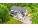 Aerial view of home, showcasing the well-manicured lawn, driveway and surrounding greenery at 179 Carrie Dr, Archer Lodge, NC 27527