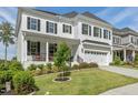 Charming two-story home featuring a landscaped yard and a covered porch at 1824 Amberly Ledge Way, Cary, NC 27519