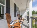 Relaxing porch with two rocking chairs and striped pillows at 1824 Amberly Ledge Way, Cary, NC 27519