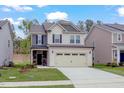 Inviting two-story home with lush green lawn and convenient two-car garage at 2007 Seford Dr, Durham, NC 27703