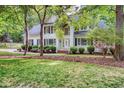 Beautifully landscaped white home with black shutters, situated on a verdant lawn at 201 Johnstone Ct Ct, Durham, NC 27712