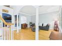Bright living room with hardwood floors, decorative columns, and ample natural light from large windows at 201 Johnstone Ct Ct, Durham, NC 27712
