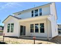 Modern home featuring a bright white siding exterior with large windows and sliding glass doors to the backyard patio at 203 Steel Spring Rd # 21, Angier, NC 27501
