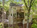 Multi-level deck with screened porch provides beautiful outdoor living space surrounded by lush trees at 205 Glenview Pl, Chapel Hill, NC 27514