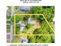 Aerial view of the lot with approximate dimensions outlined in yellow, showing surrounding houses and lush greenery at 209 N Occoneechee St, Hillsborough, NC 27278