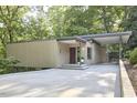 Modern house with a flat roof, covered parking and driveway leading to the front entrance at 220 Glenhill Ln, Chapel Hill, NC 27514