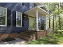Inviting front entrance with a bright green door, brick steps, and iron railings at 221 Ironwoods Dr, Chapel Hill, NC 27516