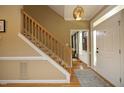 Welcoming foyer with hardwood floors, staircase, and decorative lighting at 221 Ironwoods Dr, Chapel Hill, NC 27516