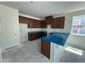 Modern kitchen features granite countertops, custom cabinets, and a central island, ready for personalization at 2410 Abbot Hall Dr, Raleigh, NC 27616