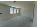 Spacious living room boasts large windows, offering ample natural light and a welcoming atmosphere at 2410 Abbot Hall Dr, Raleigh, NC 27616