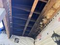 Interior attic framing showing exposed wooden beams, sheathing and insulation under repair at 249 Finley Ct, Clayton, NC 27520