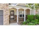 Welcoming front porch with stone accents, white pillars, and manicured greenery at 3212 at 3212 Imperial Oaks Dr, Raleigh, NC 27614