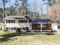Traditional split-level home with brick and siding, featuring blue shutters and a well-manicured front lawn at 3818 Hillgrand Dr, Durham, NC 27705