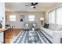 Bright living room featuring hardwood floors, a modern rug, and neutral-toned furniture at 3818 Hillgrand Dr, Durham, NC 27705