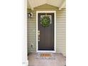 A welcoming front door with wreath, stylish light fixture, and 'HOME' doormat at 408 E Maynard Ave, Durham, NC 27704