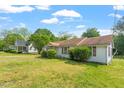 Traditional single-story home boasting a spacious front yard and mature trees, offering a serene setting at 414 N Cypress St, Wendell, NC 27591