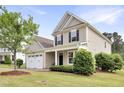 Inviting home exterior with a manicured lawn, tidy shrubbery, and a two-car garage at 4405 Aubaun Way, Knightdale, NC 27545